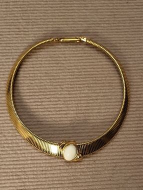 Monet gold-tone omega collar necklace with a cream oval cabochon centerpiece